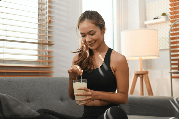 Woman taking collagen powder